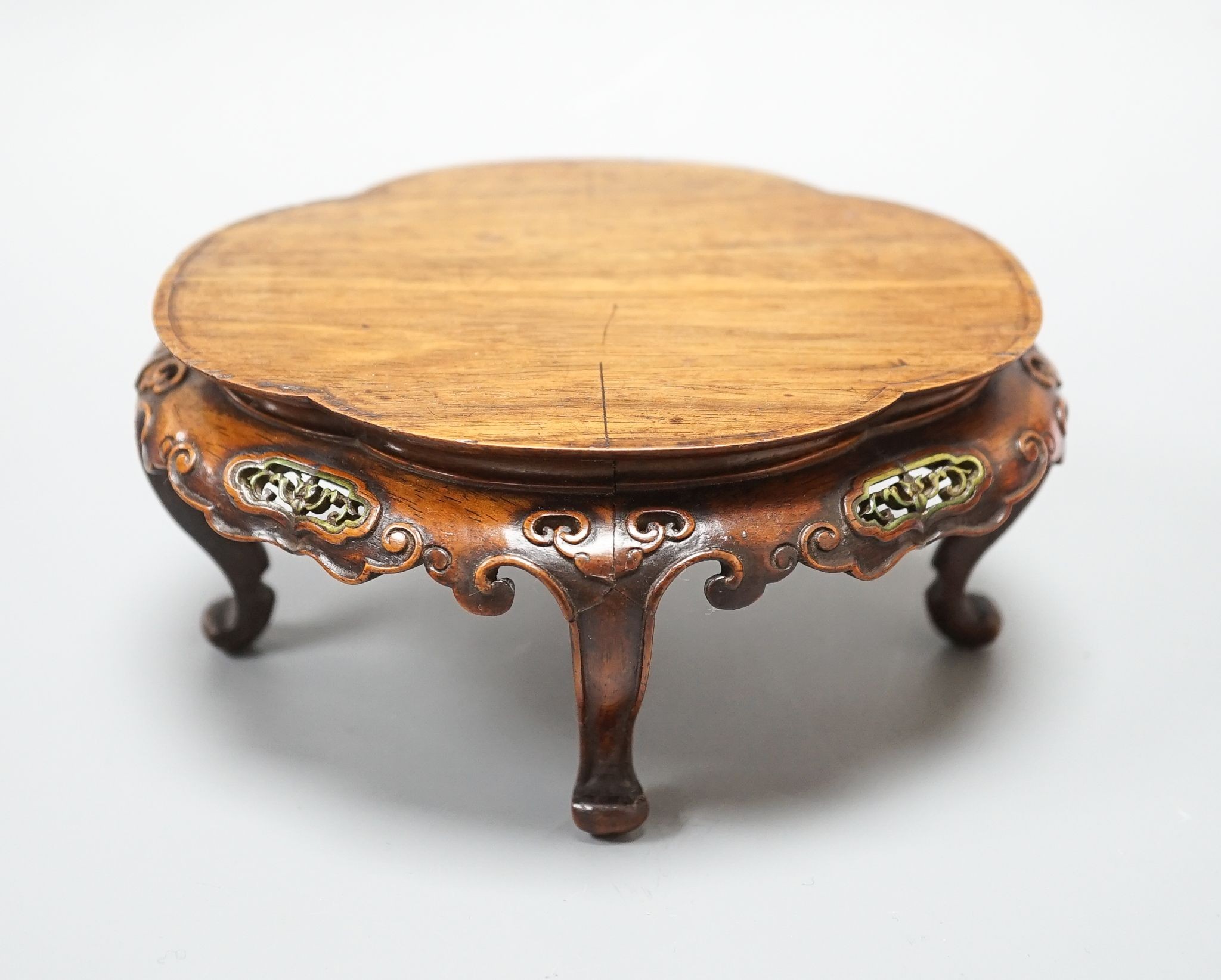 A fine Chinese oval hardwood and green stained Ivory inset stand, Qing dynasty, lacking stretcher, 15 cms wide.